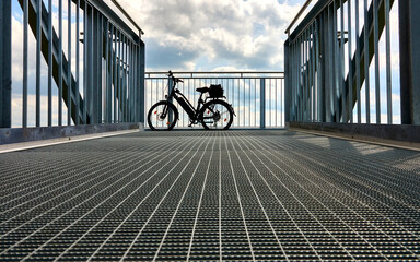 electric bicycle on a skywalk with dramatic sky in the background