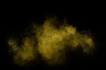 Yellow powder explosion on black background. Colored powder cloud. Colorful dust explode. Paint  Holi.