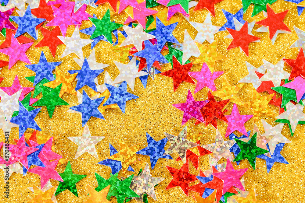 Wall mural Background of multicolored stars on colored paper with sequins