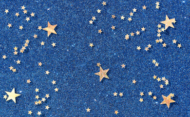 Background of gold stars on colored paper with sequins