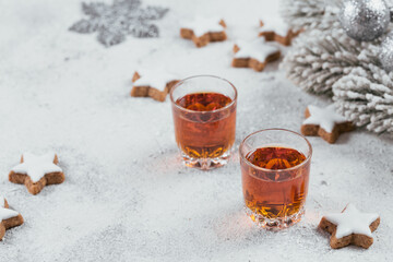 Whiskey, brandy or liquor, cookies and winter holiday decorations on white background