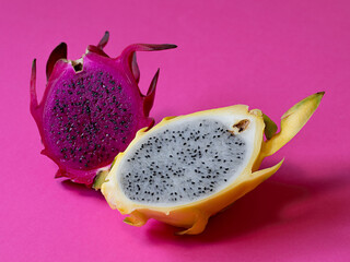 Pink and yellow pitahaya on a pink background. Close up.