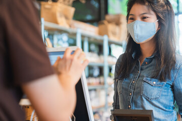 new normal after covid epidemic asian female payment progress buy scaning app by smarthine cashless...
