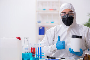 Young male chemist working in medicine lab