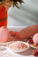 Pink bath salt and body care products with pink roses. Beauty treatment. Spa relax concept.