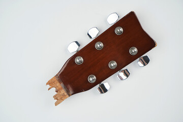 Broken guitar neck on a white background with copy space