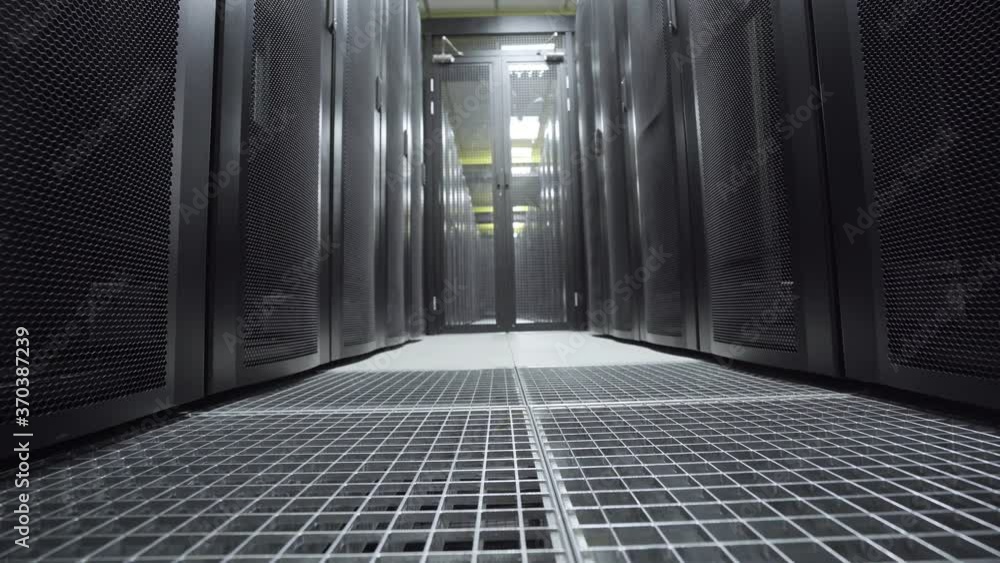 Poster floor level tracking shot of data center server room.