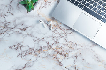 top view of a marble tabletop with a laptop and earphones flat lay top view with copy space 