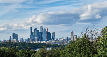 Fototapeta premium Skyscrapers with river reflections under cloudy sky in Moscow city district