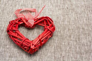 Red straw heart on a grey background