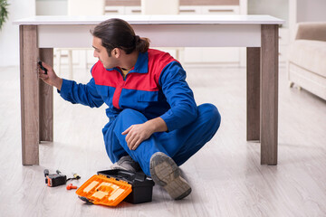 Young male carpenter working indoors