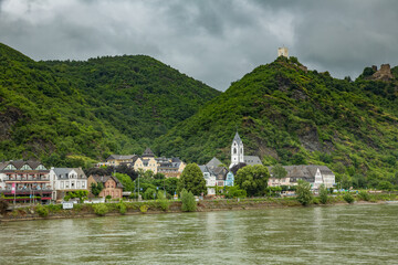 Koblenz, Germany - 7/15/2013:  A church and hotel  under the ruins of an ancient castle, along the Rhine River in wine country near Koblenz Germany