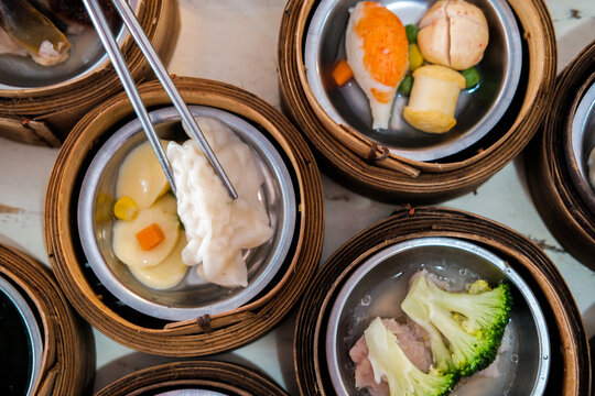 Asian Girl Eating Dim Sum In Chinese Restaurant