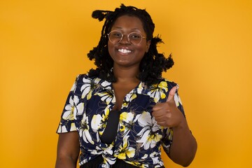 Good job! Portrait of a happy smiling blue eyed young successful woman giving thumb up gesture...