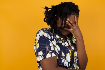 Indoor portrait of beautiful woman with stylish haircut, wearing casual clothes, making facepalm...