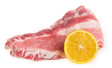 Raw pork ribs with lemon on a white background isolate