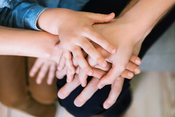 Parents And Kids Holding Hands Together Indoors, Closeup