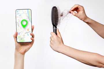Females hands clean the comb from fallen hair, and holds a smartphone with an online maps app. White background. The concept online search of beauty salon and hair care