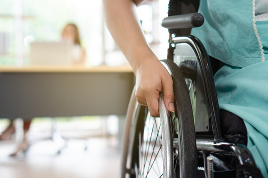 close up picture of young disabled woman sitting in the wheelchair. disability and handicapped concept