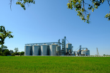 Grain elevator silos. Agriculture factory. Storage tanks agricultural crops processing plant.