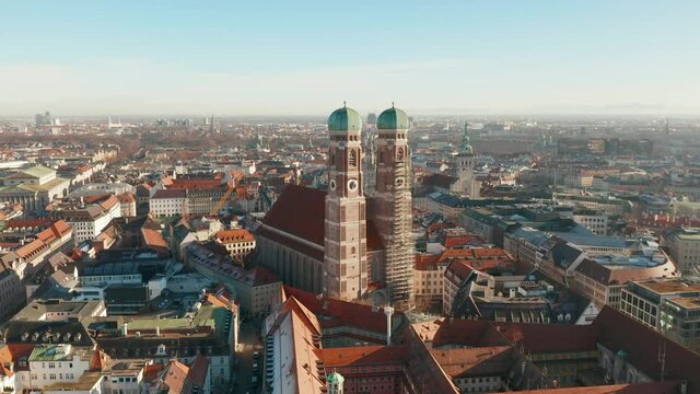 Aerial footage: Orbiting the Cathedral of Our Dear Lady (Frauenkirche) and flying above its towers - Munich, Germany