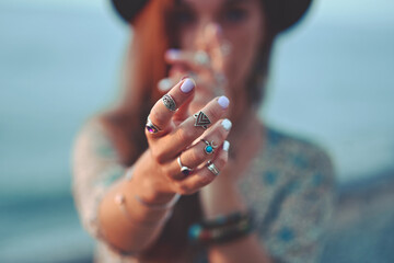Bohemian chic gypsy brunette woman with manicure wearing hands jewelry accessories, felt hat and dress. Boho detail close up © Goffkein