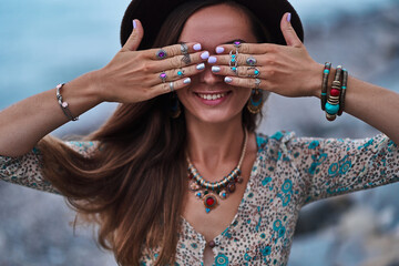 Bohemian chic gypsy smiling happy free woman with manicure wearing hands jewelry accessories, felt...