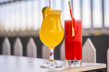 A glass of antioxidant watermelon juice and orange juice decoration with plastic straw in a restaurant in Bali