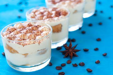classic Italian dessert tiramisu in glasses, decorated with cocoa powder