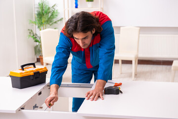 Young male carpenter working indoors