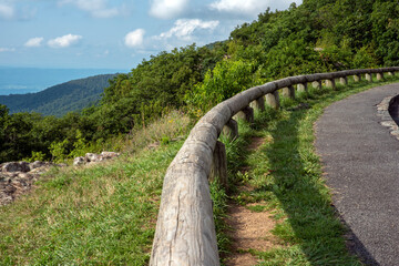 wooden fence along with the hill road