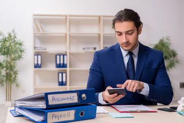 Young male financial manager in the office