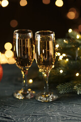 Ribbon, baubles and wine against Christmas lights.