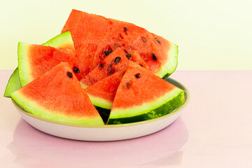 Delicious red sliced watermelon on a plate. Stock of fiber and fructose. Summer food concept.
