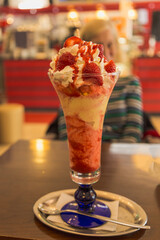 Strawberry ice cream bowl on wooden table