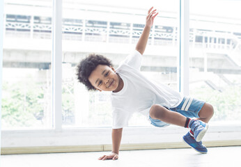 Obraz premium African boy playing and dancing in living room at home