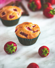 Cupcakes with strawberries on a marble background