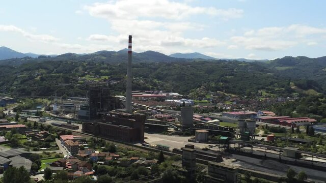 Chimney of chemical factory in Langreo, village of Asturias,Spain. Aerial Drone Footage