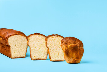 Sliced bread on blue background. Hokkaido sourdough milk bread. Homemade loaf