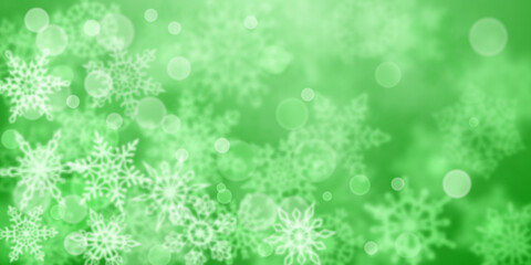 Christmas background of blurry snowflakes in green colors