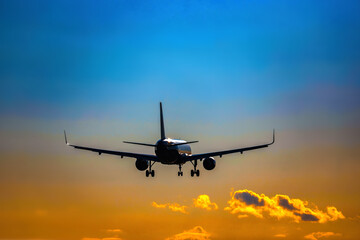 Naklejka na ściany i meble Plane flying tail and landing on a sunset. High quality photo