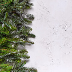 Christmas white grunge background, top view, decorated with fir twigs, berries, baubles. Christmas, New Year decoration, pine tree branches and cones on light background, flat lay, copy space.