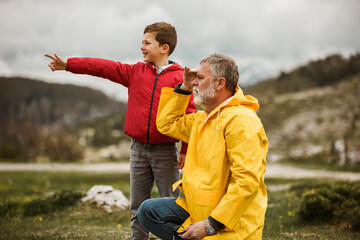 Father and son in the countryside on a rainy day