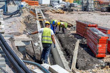 Workers are installing concrete drains to prevent flooding