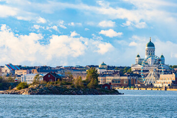 Obraz premium Finland. Panorama of the Harbor of Helsinki. An island in the Gulf of Finland with houses on the background of Helsinki. Ferris wheel in the Harbor. The sky wheel. Cathedral Of St.Nicholas. Suurkirkko