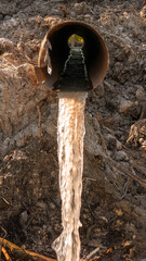 Waste water flows from the pipe,pollution of nature and the environment,industrial mud.