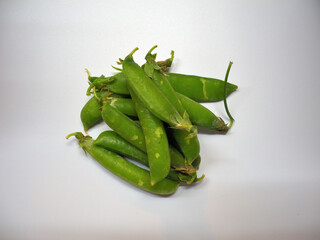 A lot of pea pods on a white background. Legumes, vegan product.
