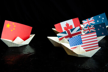 paper ship with Flags of USA and China concept of conflict, shipment or free trade agreement and...