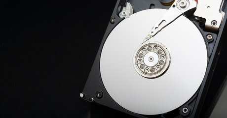 Internal parts of the hard drive. HDD. Computer memory. Modern technologies. Computer repair. Data storage concept. Black background. Free space for text. Recover lost data.