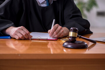 Old male judge working in courthouse